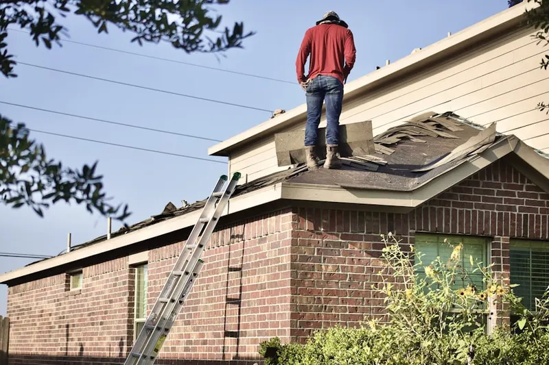 Professional roofer working on a residential roof in Old Town North